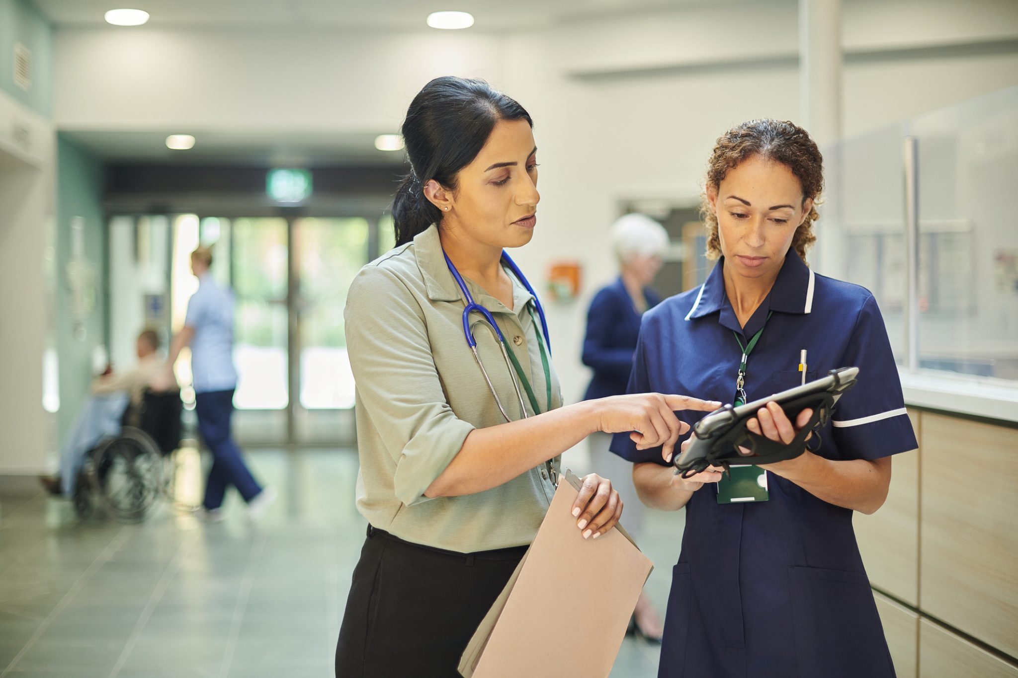 Health care professionals reviewing tablet
